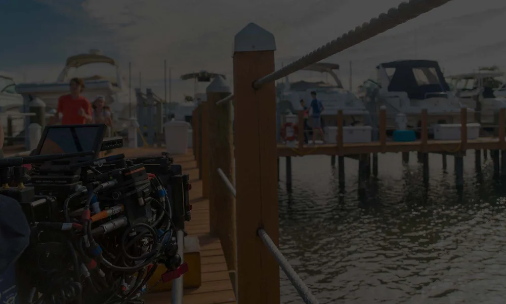 A camera crew shooting on a working waterfront
