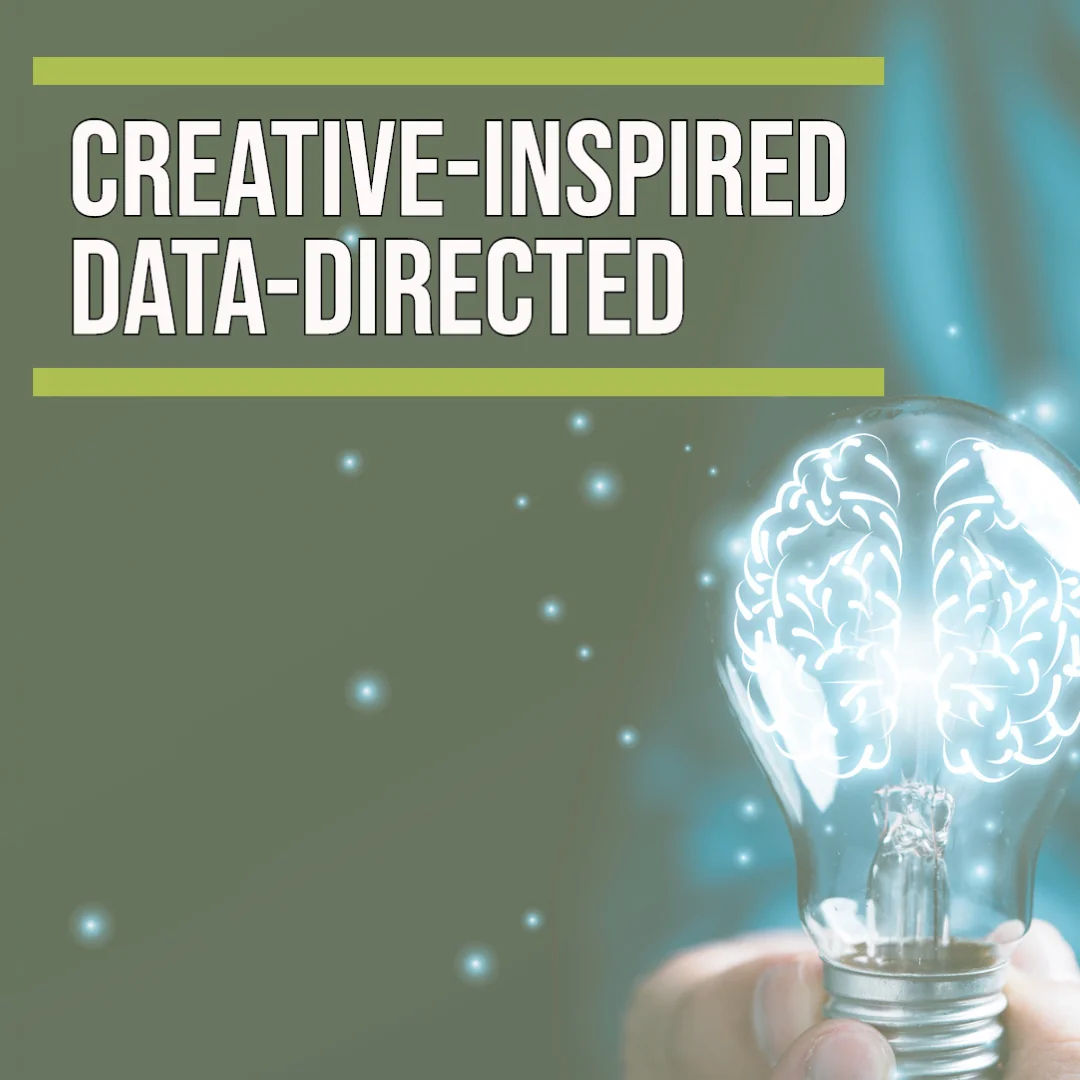 A hand holds a glowing light bulb with a illuminated brain inside, against a green and teal background.